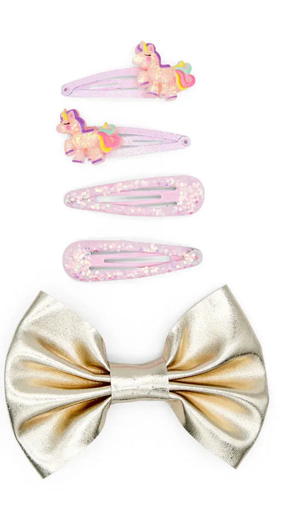 Set of hair accessories including a large bow and smaller clips with unicorn designs on a white background.