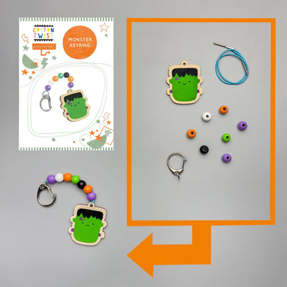 Monster keyring kit with green monster design on a gray background