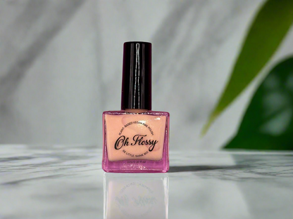 OH Flossy nail polish sitting on a bathroom table.